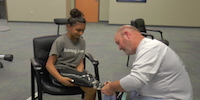 Young Girl Having Prosthetic Limb Adjusted